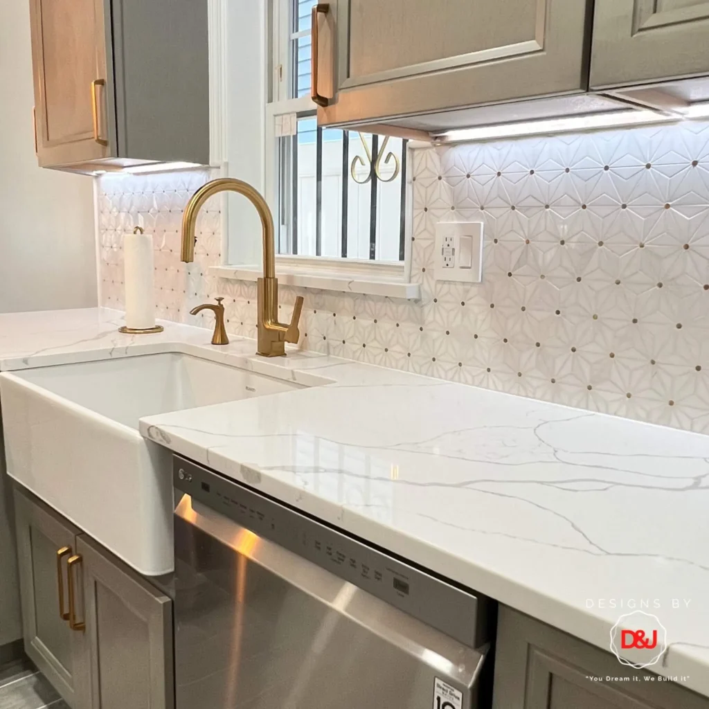 Luxury kitchen countertop with gold fixtures and marble design by expert remodelers in NYC.