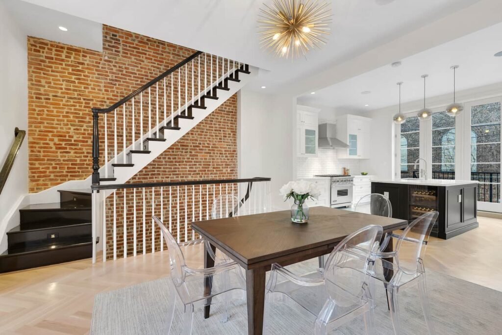 Brownstone renovation in NYC and Northern NJ featuring exposed brick wall, modern staircase, and open kitchen by Designs by D and J.