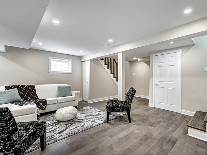 Finished basement renovation with open living area and recessed lighting by expert contractors in New Jersey.